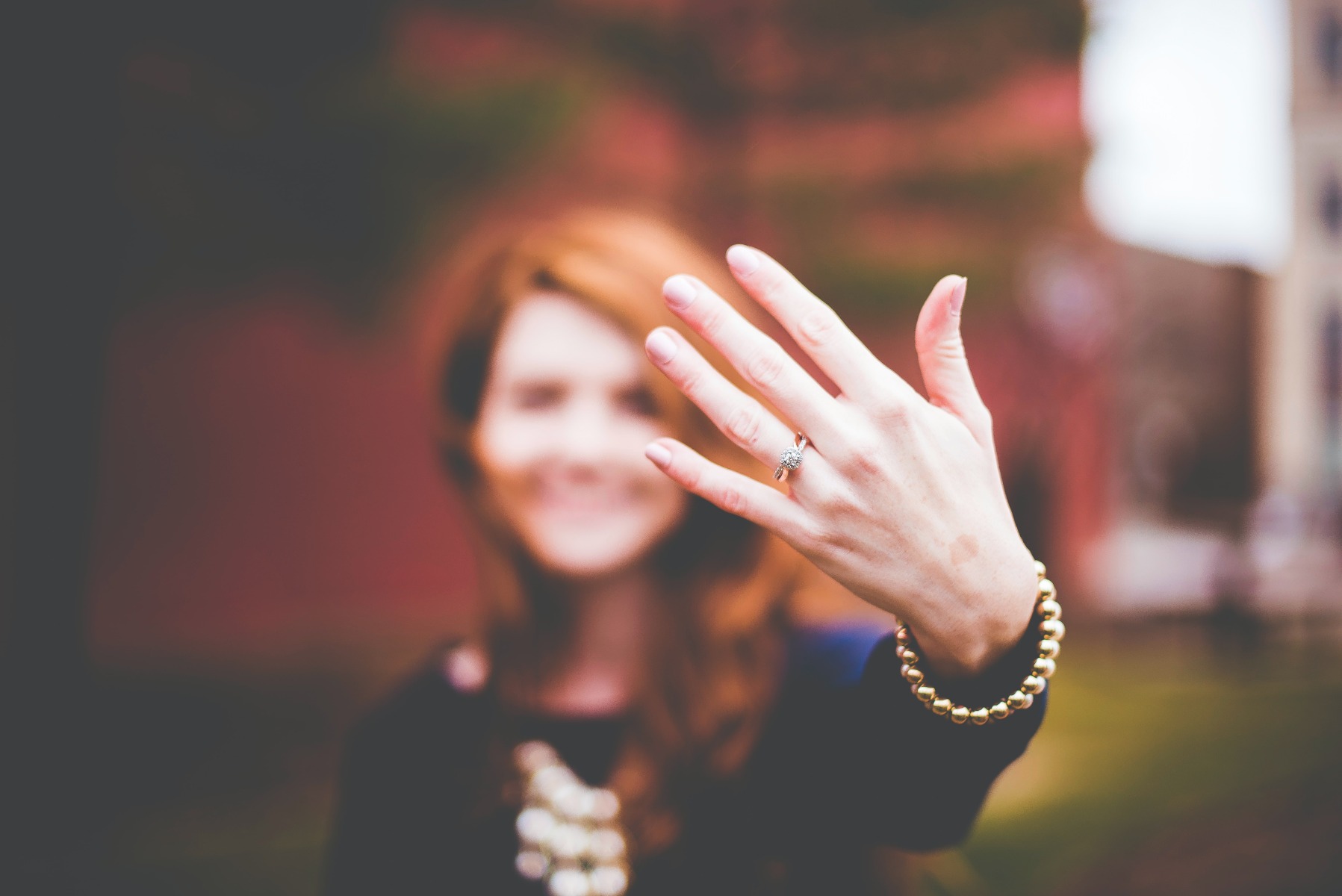 Woman showing off her engagement ring.