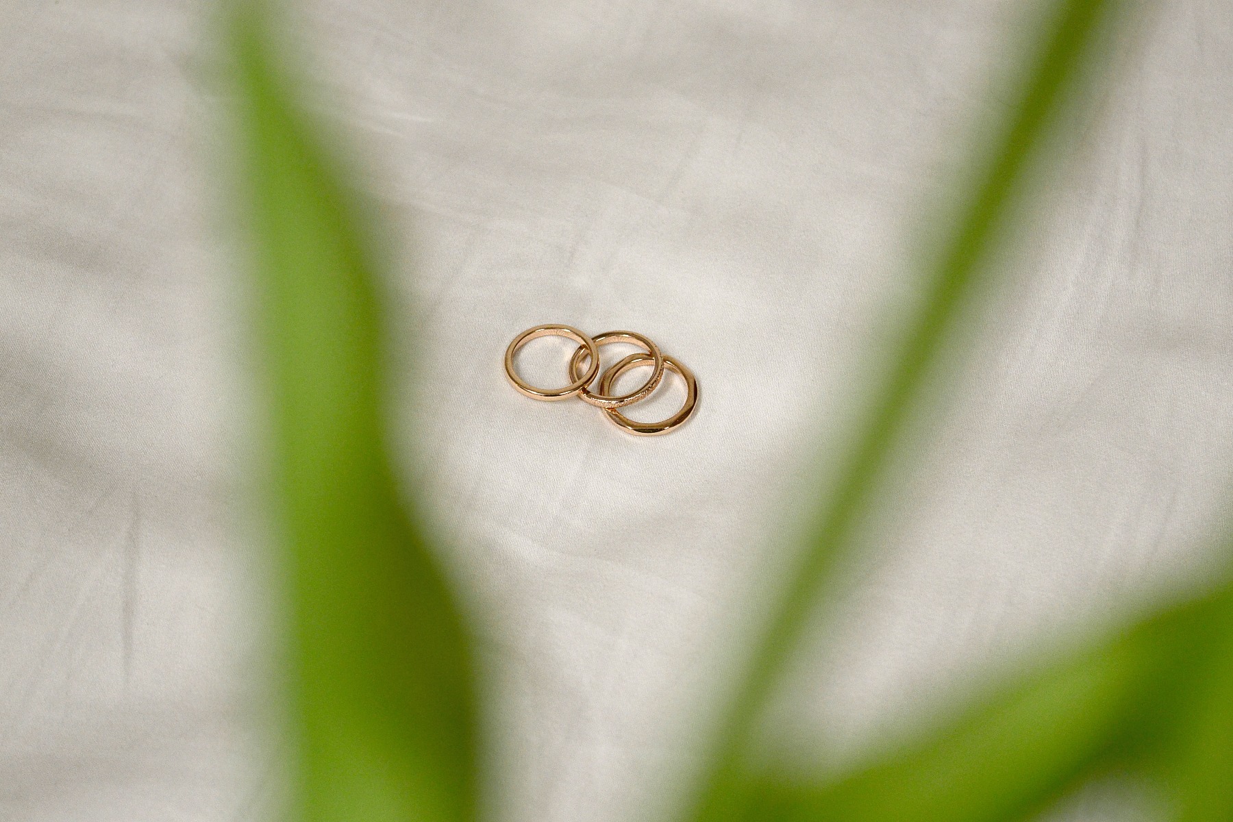 Three different rings laying on the pavement. 