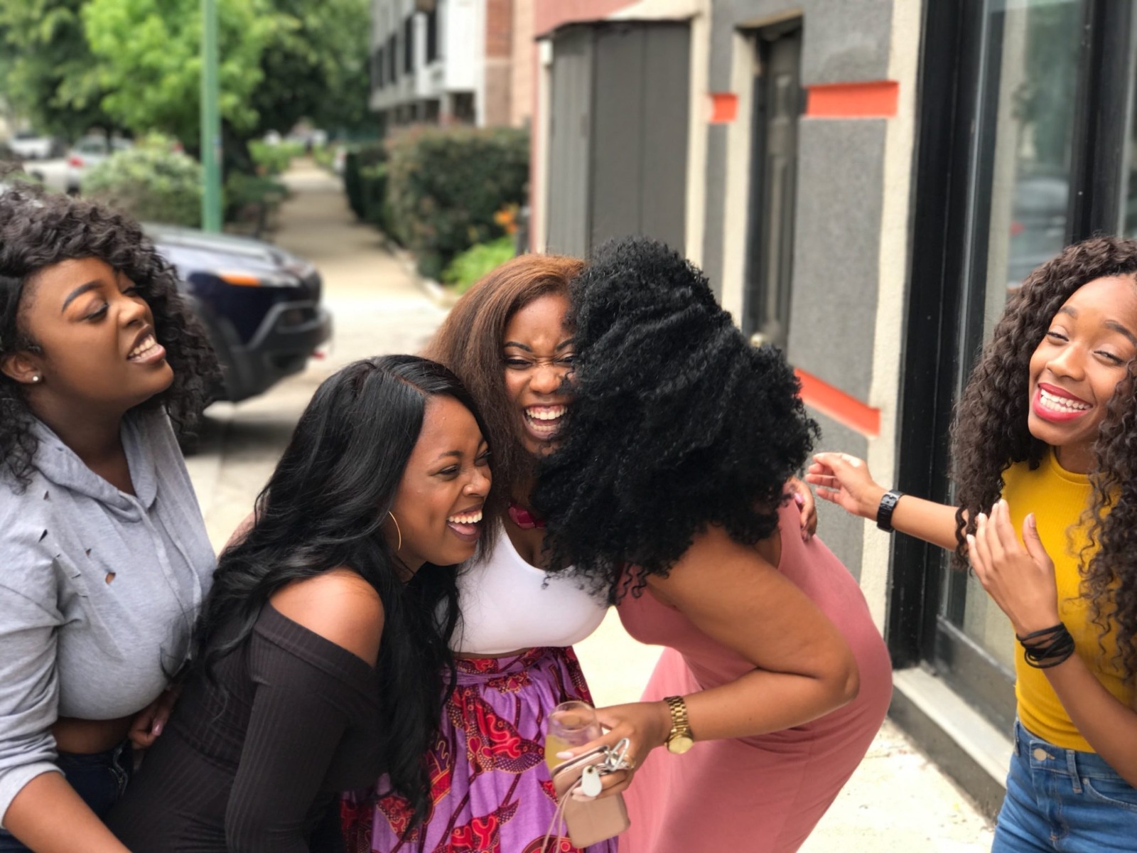 Four women laughing together