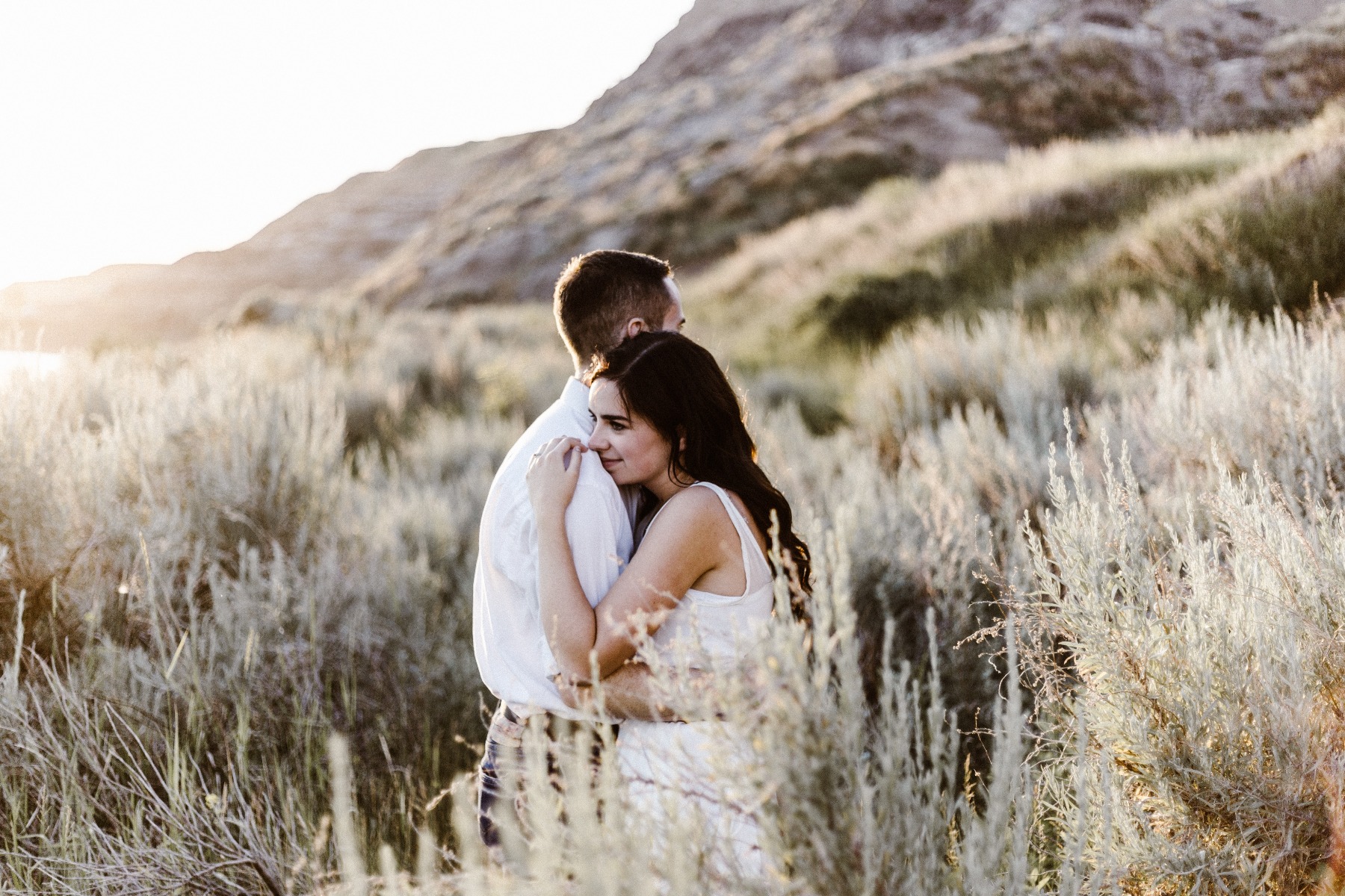 A man and a woman holding each other close in a warm embrace